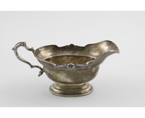 A LATE GEORGE V SAUCEBOAT. In the style of an early George II example, on a spreading oval foot, with a flat-chased frieze, a