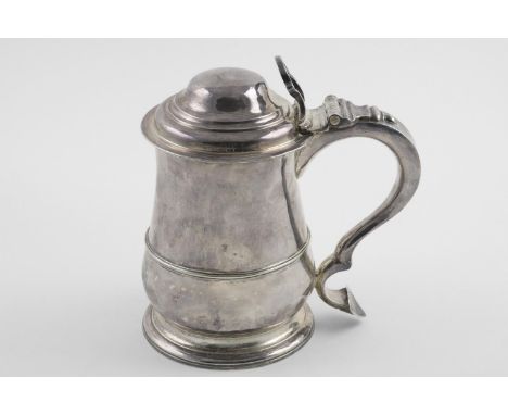 A GEORGE II TANKARD. of baluster form, with an applied moulded girdle, a spreading circular foot, the domed cover with a chai