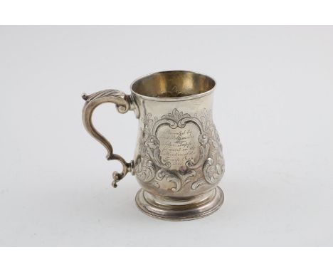 A GEORGE III MUG. of baluster form, with a scroll handle and later foliate decoration, inscribed, gilt interior, maker's mark
