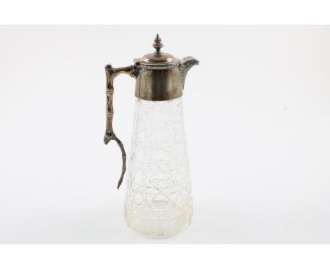 A LATE VICTORIAN MOUNTED GLASS CLARET JUG. of tapering form, with a naturalistic handle, the cover with a bead border and an 