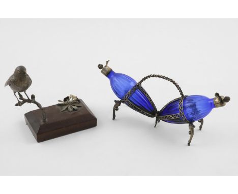 AN ELIZABETH II PARCELGILT CAST FIGURE OF A ROBIN. on a bevelled wooden base, perched on a branch above a flowering plant, by