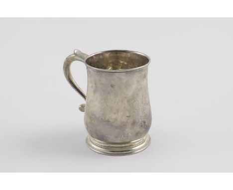 A GEORGE II BALUSTER MUG. with a scroll handle and spreading circular foot, crested, London 1731 (maker's mark partially worn