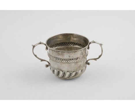 AN 18TH CENTURY PORRINGER. with two scroll handles, a wrythen-fluted lower body and an embossed rope-work girdle, scratched "
