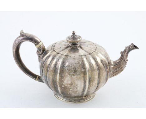 A WILLIAM IV TEAPOT. of melon-fluted form, with a later Victorian C-scroll handle, engraved decoration, and a flaring circula