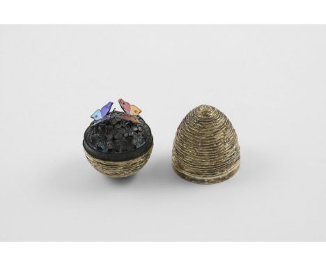 BY STUART DEVLIN:-. a late 20th century silvergilt "surprise" egg, with a textured surface, opening to reveal two butterflies
