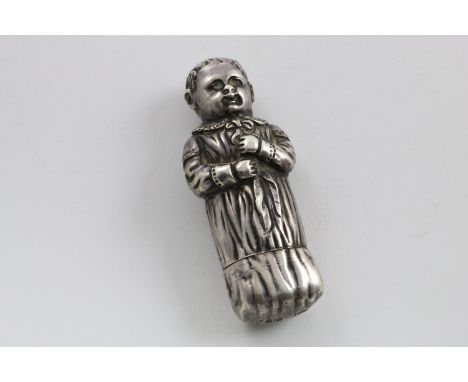 A VICTORIAN FIGURAL CASE. in the form of a very young boy in his nightgown, tied up at the neck with a ribbon and the bottom 
