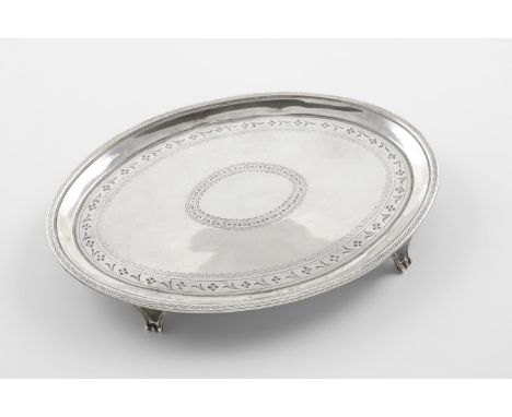 A GEORGE III OVAL TEAPOT STAND. with engraved decoration and resting on four feet, by Elizabeth Jones, London 1788; 7" (17.8c