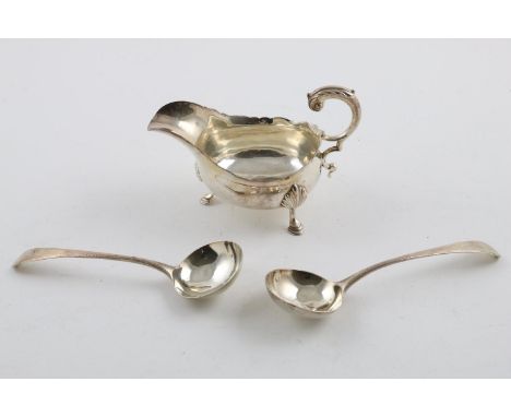 A GEORGE III SAUCE BOAT. with a wavy rim, a leaf-capped flying scroll handle and resting on 3 hoof feet, by David Mowden, Lon