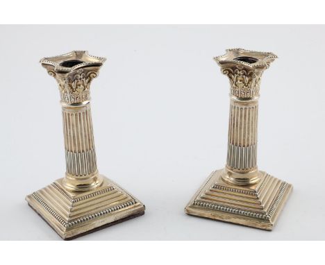 A PAIR OF LATE VICTORIAN CANDLESTICKS. in the form of Corinthian Columns, with detachable nozzles and loaded bases, by James 