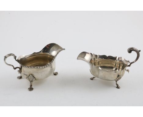 AN EDWARDIAN SAUCE BOAT. with a gadrooned border, a scroll handle and three shell feet, by Thomas Bradbuy &amp; Sons, London 