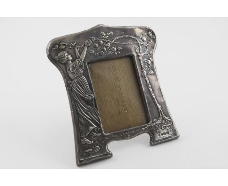 AN EDWARDIAN ART NOUVEAU WOODEN MOUNTED PHOTOGRAPH FRAME. decorated in relief with a young lady picking fruit from a tree, wi