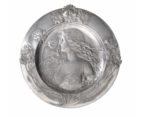 WMF, a Jugendstil silver plated pewter shaped circular wall plaque by WMF, embossed with a half portrait of a maiden surround