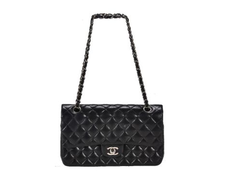 Chanel, a black leather quilted handbag, no. 9616231, with white metal hardware, a woven shoulder strap and a single exterior