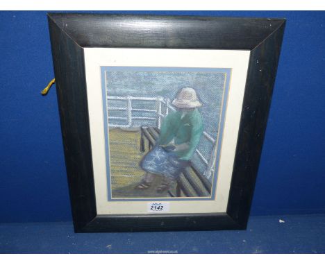 A framed and mounted charcoal drawing of a lady sitting on a bench by the sea reading a book, no visible signature, 12 1/2'' 