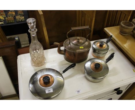 A glass decanter and stopper; a copper kettle; and a quantity of stainless steel saucepans