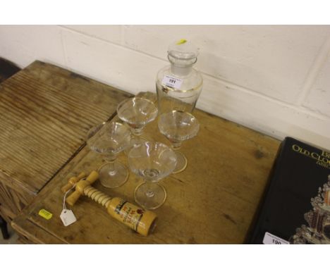 A glass cocktail shaker with a set of four glasses; and a wooden corkscrew 
