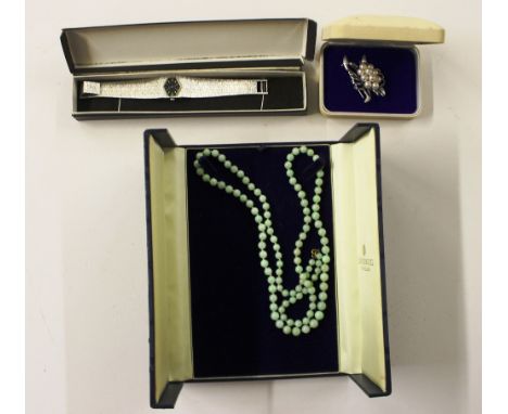 A jade bead necklace together with a Accurist ladies wrist watch; and a silver brooch 