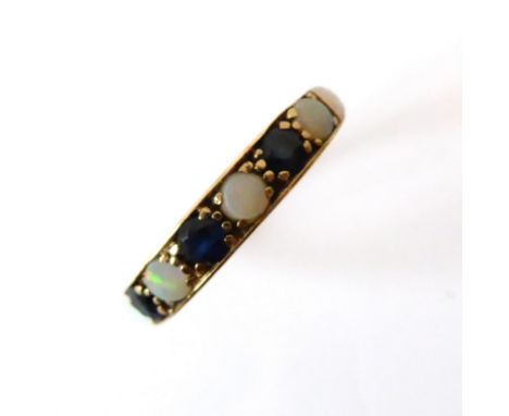 A 9ct yellow gold, sapphire and opal seven stone ring - hallmarked 1975, set with three round cut sapphires and four round ca