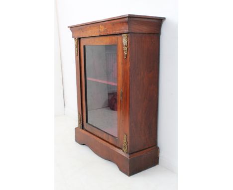 A figured walnut and gilt-metal-mounted pier cabinet: single glazed door below boxwood marquetry opening to reveal single she