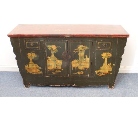 A Chinese painted and lacquered cabinet: probably early 20th century, the cleated, red lacquered top over a black lacquer bas