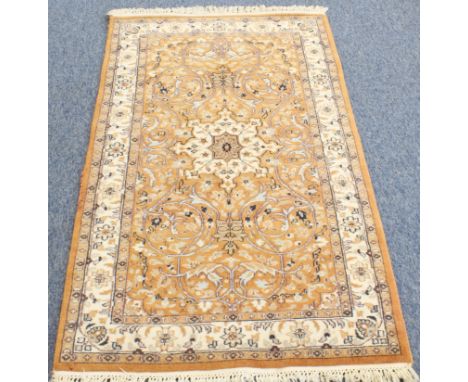A Kashmir rug; light terracotta ground with ivory central medallion and main ivory border (156 x 93 cm) * Condition: Good  
