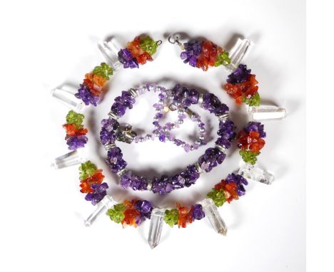 A vintage rock crystal, amethyst, peridot and carnelian necklace - the nine slightly tapered, hexagonal rock crystals divided