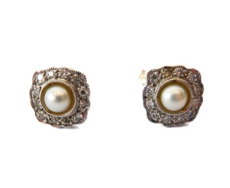 A pair of 14ct white gold, cultured pearl and diamond cluster earrings - the single half-pearls within a millegrain border of