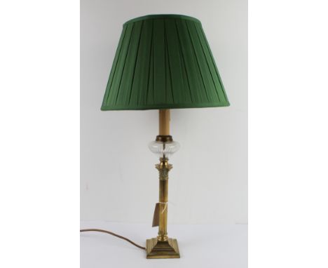 An early to mid 20th century brass oil lamp modelled as a Corinthian column and with etched&nbsp;clear-glass reservoir. (Now 
