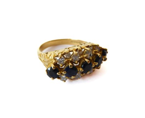 An 18ct yellow gold, sapphire and diamond three row ring - hallmarked Birm. 1992, with a central row of five round cut sapphi