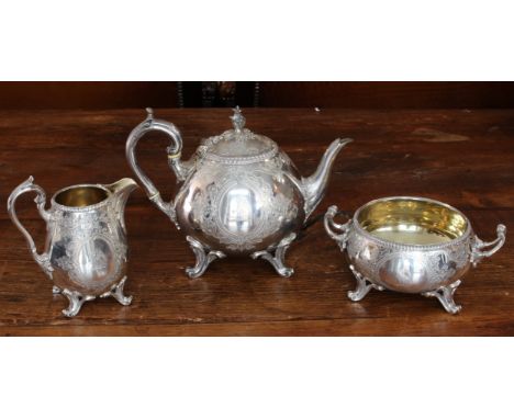 A large and heavy three-piece hallmarked silver tea service comprising teapot, two-handled sugar and milk jug (with gilded in