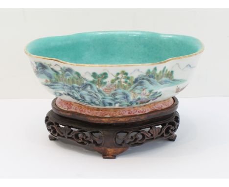 A 20th century Chinese porcelain bowl of quatrefoil form: matt duck-egg blue glazed interior; the exterior hand-decorated in 