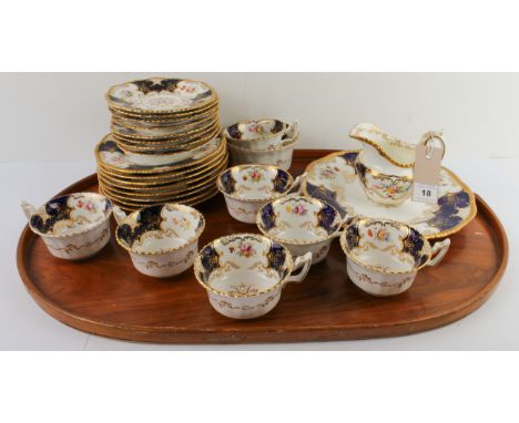 An early 20th century Coalport porcelain tea service. Each piece hand-gilded and decorated with floral vignettes within reser