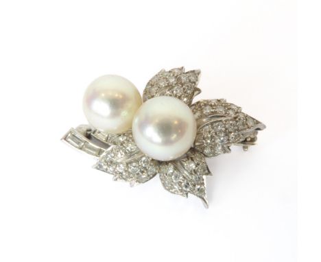 A mid-century platinum, pearl and diamond foliate brooch - probably 1950s, marked 'P.T.', set with baguette cut and eight cut