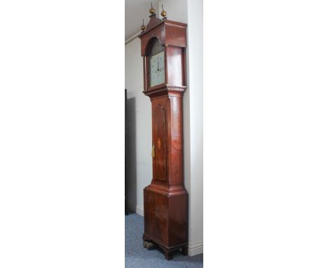 An early 19th century figured mahogany eight-day longcase clock. The 13-inch broken-arch white-painted dial below three gilt-