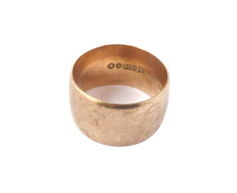 A 9ct yellow gold wedding ring - the broad, plain band hallmarked London 1965, size Q, weight 10g.
