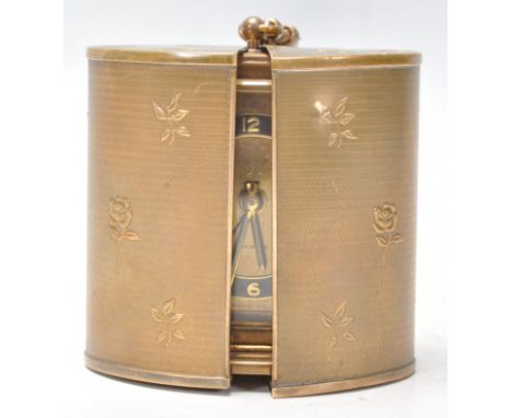 A vintage retro travel alarm clock by Europa with a brass and ebonised chapter ring featuring arabic and baton numerals. The 