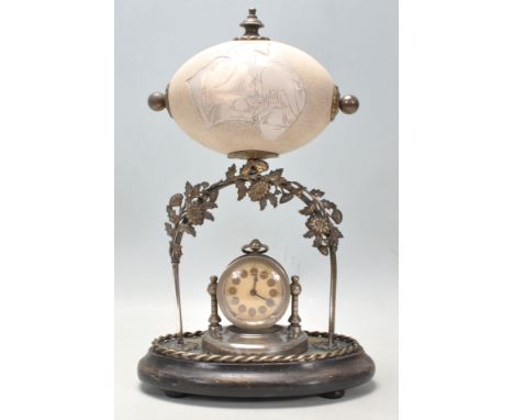 A 19th Century Victorian carved emu egg mantle clock depicting a kangaroo and a large bird with an Australian cartouche. Belo