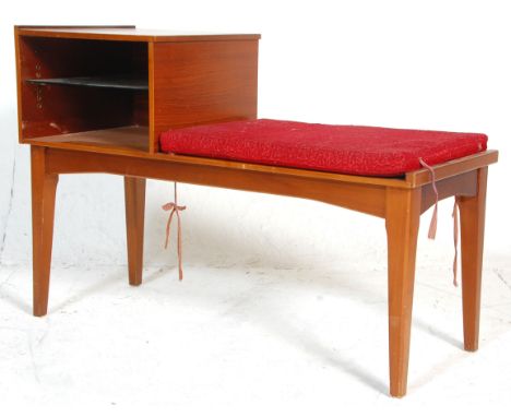 A retro mid century teak wood telephone table bench. Raised on tapering legs with a moquette upholstered pad seat flanking an