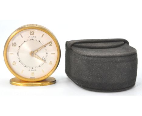 A 1960's Jaeger Le Coultre mid century travel alarm clock complete in the original suede travel case / box. Circular dial and