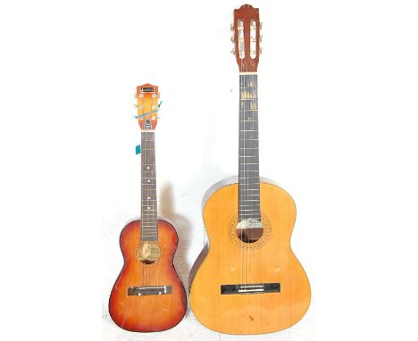 A vintage Audition made acoustic six string guitar having a reinforced steel neck, original tag and paper label to inner toge