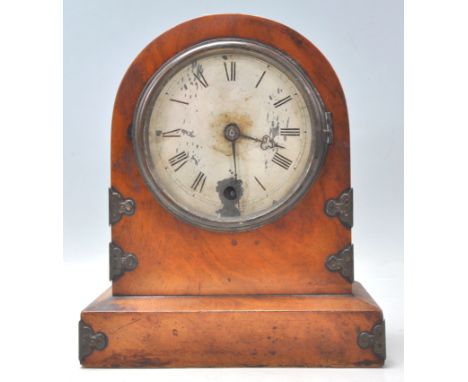 A 19th century English walnut cased mantel clock with 24 hour brass movement. The clock on plinth base with arched case havin