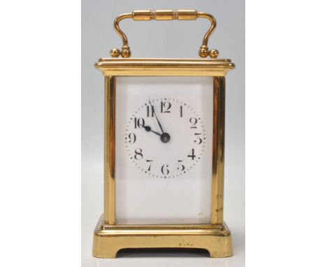 A good quality early 20th century brass cased carriage clock having enamel dial with Roman numeral chapter ring, open window 