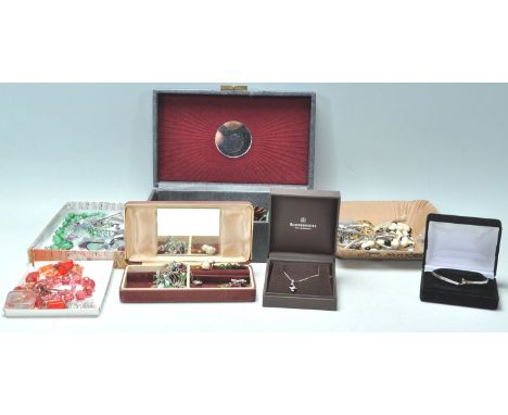 A collection of vintage costume jewellery across multiple jewellery boxes to include a wide selection of beaded necklaces, a 