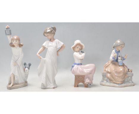 A group of four Valenican Nao porcelain figurines to include a girl wearing a white dress, a seated girl with a flower pot, a