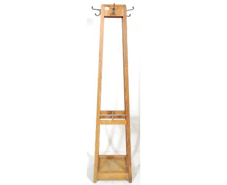 A vintage retro mid century oak framed Industrial office / school coat hook hall stand having four cast metal hooks to the to