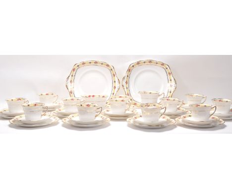 A Fine Bone China English tea service by Roslyn China having floral banded borders comprising twelve cups, twelve saucers and