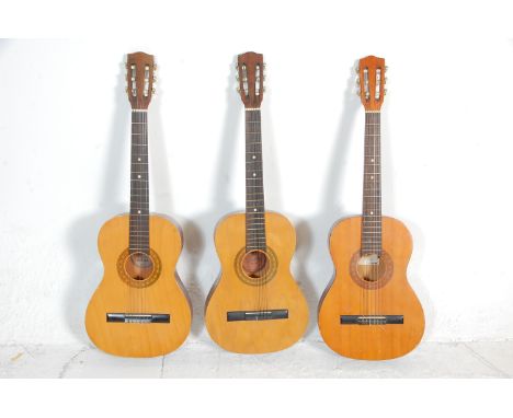 A group of three six string acoustic guitars. All guitars being Encore makes model ENC 36N having inlaid decoration with mark