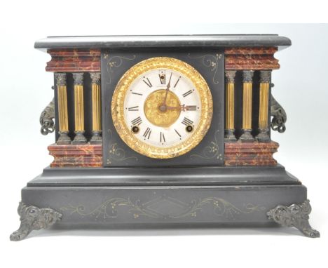 A Victorian style faux red marble and slate 24hr mantel clock featuring a round brass &amp; white enamel face with a Roman nu