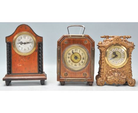 A collection of antique mantel clocks to include a faux birds eye maple German mantel clock with a white enamel face and arab