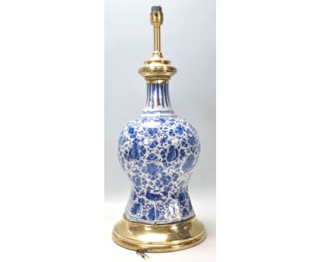 Abn 18th Century Delft blue and white ceramic lamp of waisted form having hand painted floral and bird decoration throughout 